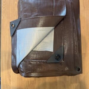 Folded Brown Tarp with Reinforced Corners and Grommets